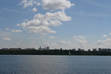 Sunny sky with clouds on the Bay with seagulls and sailboat