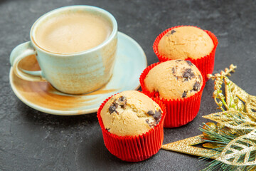 Front close view of delicious coffee small cupcakes on dark background