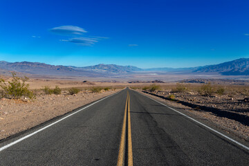 Fototapeta na wymiar View of an empty road leading to the Death Valley, in California, USA.