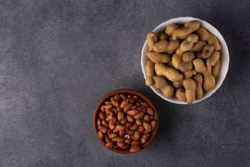 Peanut fruits and seeds in bowls. View from above.
