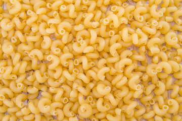 Pasta raw close up background. Delicious dry uncooked ingredient for traditional Italian cuisine dish. Textured variety shapes.