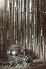 Silver Disco ball, star confetti, silver and gold metallic background.
