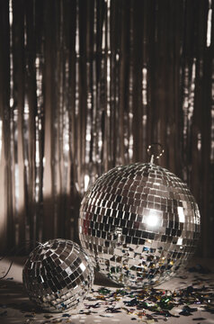Silver Disco ball, star confetti, silver and gold metallic background.