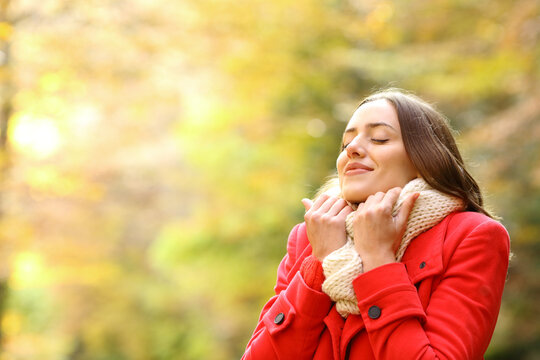 Beauty Woman In Red Jacket Grabbing Scarf In A Park