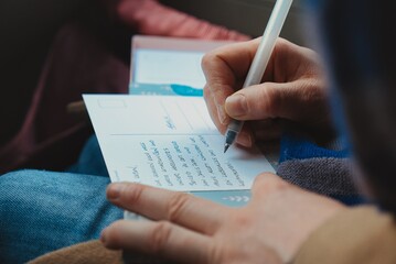 Hand of Person Writing Postcard