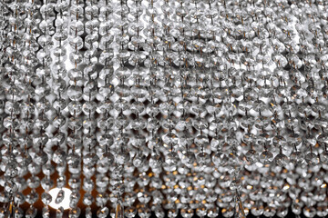 Fototapeta premium background with crystal chandeliers. Crystal chandelier close-up. Glamour background with copy space