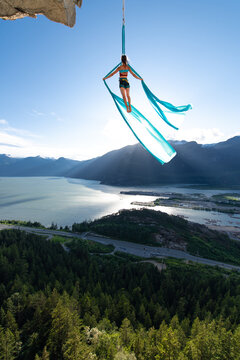 Woman on aerial silks on the Stawamus Chief in Squamish, British Columbia, Canada