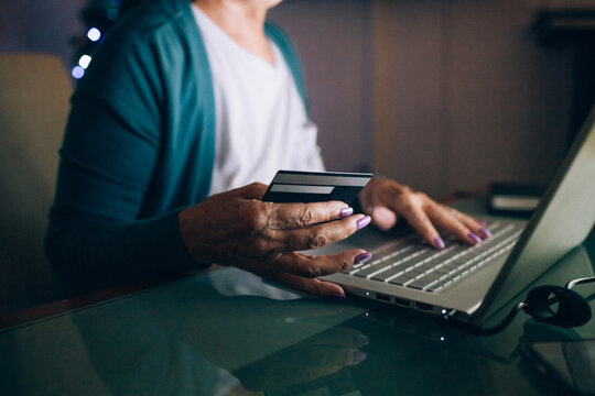 Woman shopping on laptop with credit card