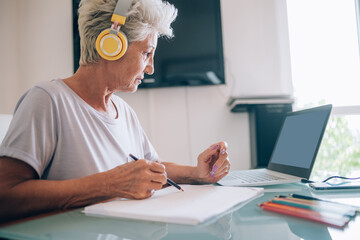 Woman taking online art course at home