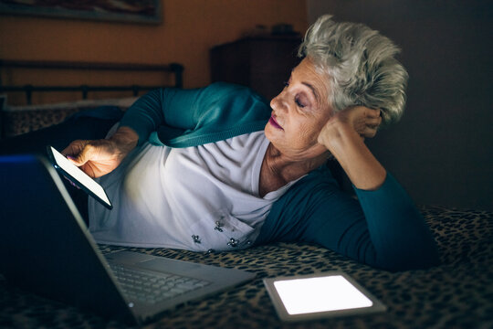 Woman using different screens at night