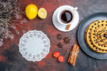 top view yummy sweet pancakes with tea on dark floor cake milk sweet dessert