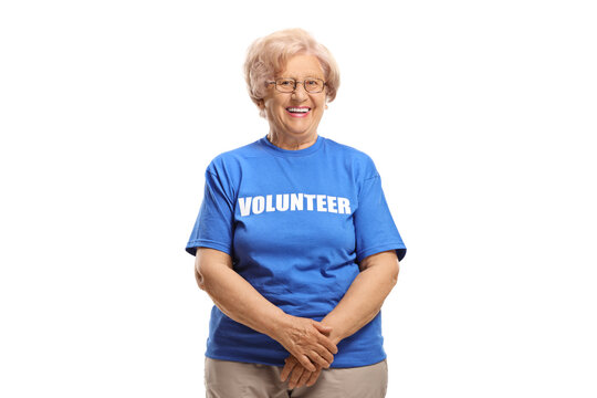 Elderly woman wearing a blue volunteer t-shirt smiling at the camera