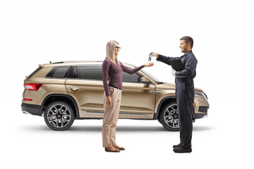 Fototapeta na wymiar Auto mechanic returning keys from a SUV to a young woman