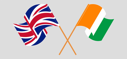 Obraz premium Crossed and waving flags of the UK and Republic of Ivory Coast