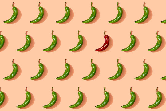 Pattern of green chili peppers with single red one