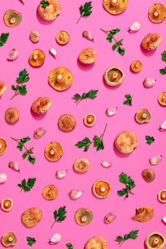 Large group of mushroom, parsley and garlic on pink background