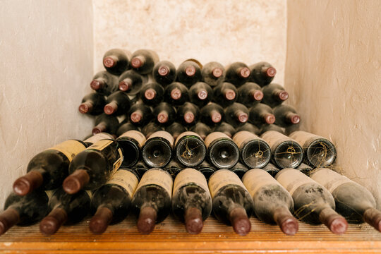 Stack of old wine bottles at cellar