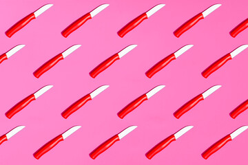 Pattern of table knives on pink background
