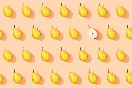 Pattern of fresh yellow pears with single halved one