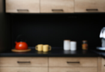 Fototapeta na wymiar Blurred view of kitchen interior with modern furniture