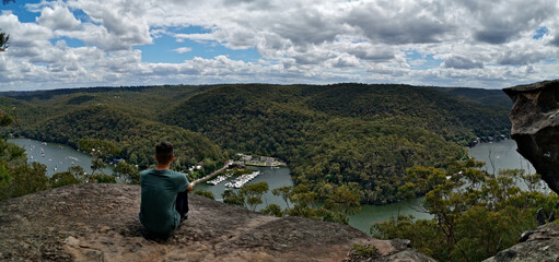 Beautiful panoramic view of a winding river with mountains, valleys and blue sky with white clouds, Berowra Heights, Berowra Valley National Park, Sydney, New South Wales, Australia  © Ivan