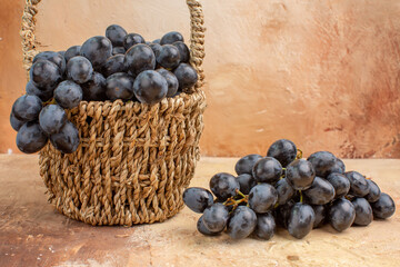 front view fresh black grapes inside basket on light background fruit wine mellow ripe photo