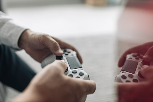 Businessman hands holding video game remote control at office