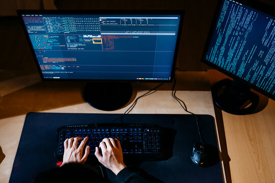 Hacker hands working on computer at office
