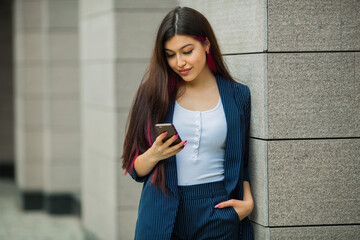 beautiful young female in suit with mobile phone
