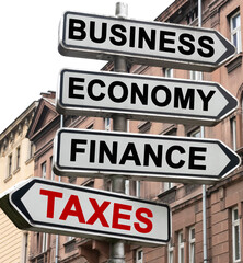 The road indicator on the arrows of which is written - business, economics, finance and TAXES