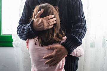 Grandfather comforts his crying granddaughter.