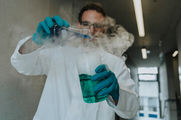 Scientist mixing liquid solution in flask while standing at clinic corridor