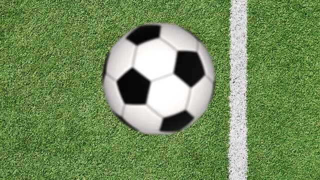 Rotating soccer ball bauncing on green football field.