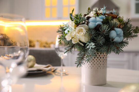 Beautiful winter bouquet on white table in kitchen