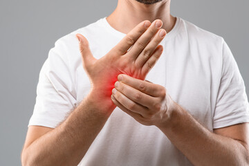 Unrecognizable man scratching itch on his hand