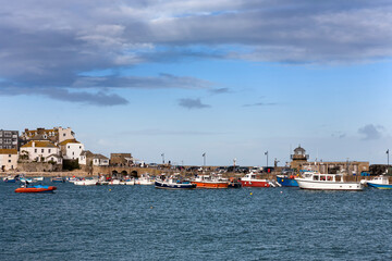 Fototapeta na wymiar St. Ives' harbour and Smeaton's Pier at high tide from Wharf Road, St Ives, Cornwall, UK