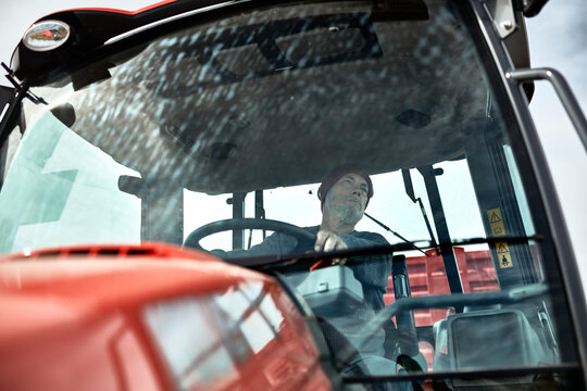 Farmer working with tractor at farm