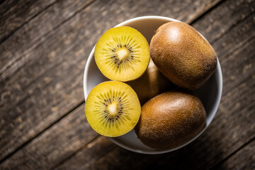 Halved ripe yellow kiwi fruit.