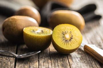 Halved ripe yellow kiwi fruit.