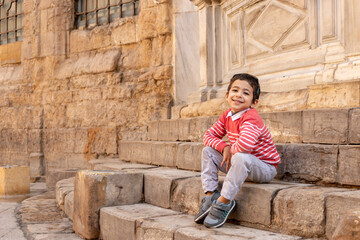 happy child visits ancient places and walking in el Meiz street, Cairo, Egypt