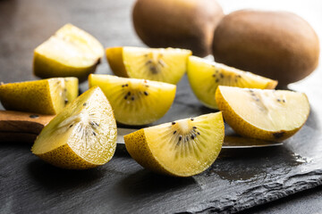 Halved ripe yellow kiwi fruit.
