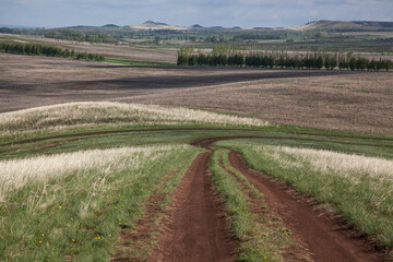 Open spaces of Bashkortostan. Hilly terrain. Winding dirt road. Small areas of forest. Lots of free space for insertion.