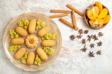 a plate of cookies and cinnamon sticks and star anise and a bowl of palm on the marble ground