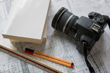 Stationery and camera on blueprint