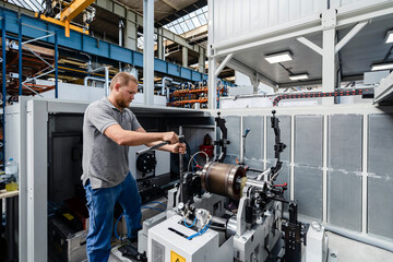 Expertise repairing machine while standing at factory