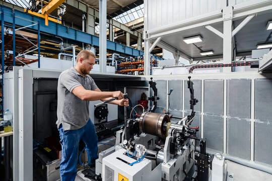 Expertise repairing machine while standing at factory