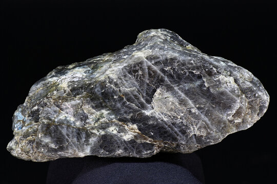 Plagioclase (feldspar) - unworked rock specimen on dark background close up. Russia
