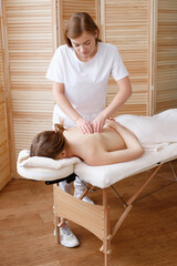 masseur delegates therapeutic massage to the patient
