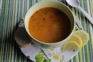 soup on plate and lemon