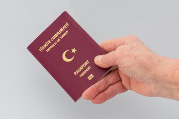 Turkish citizen public passport on the gray background.